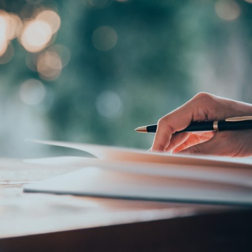 Close up women hand on writing on notebook and work with smart p